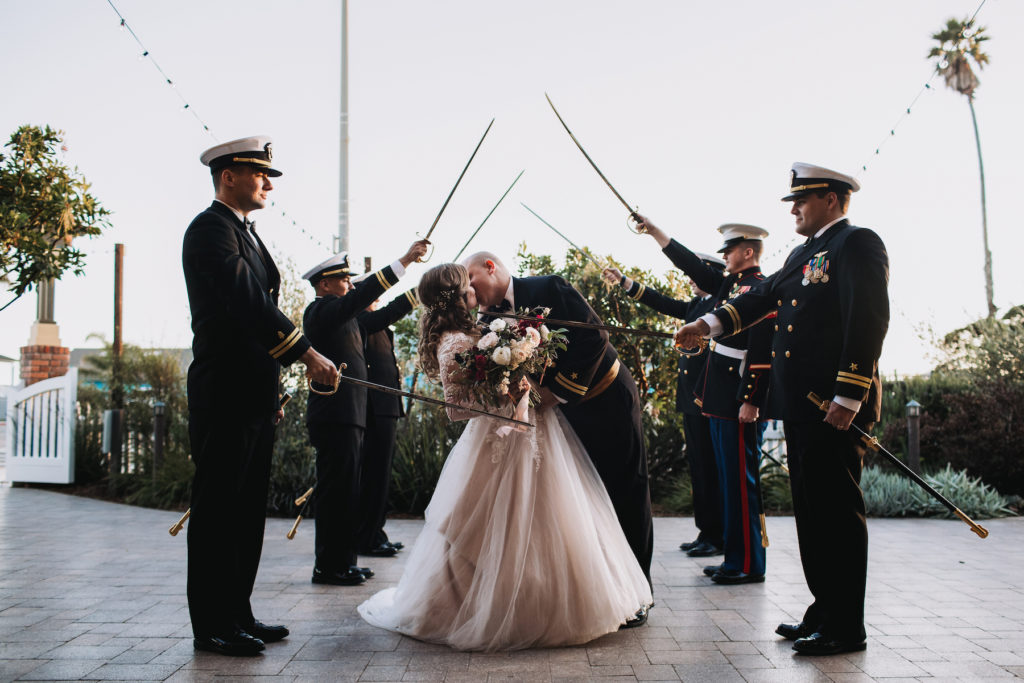 Military sword salute for wedding first kiss romantic kiss burgundy and blush wedding flowers