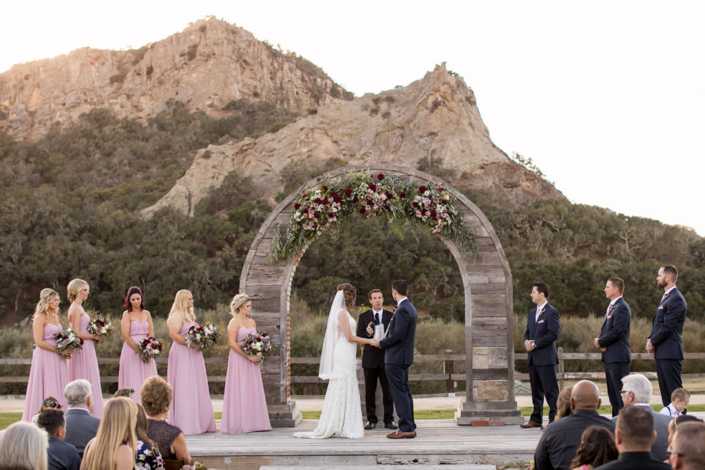 Holland Ranch wedding flowers with burgundy and blush flowers on a rustic arch Flowers by Denise wedding flowers