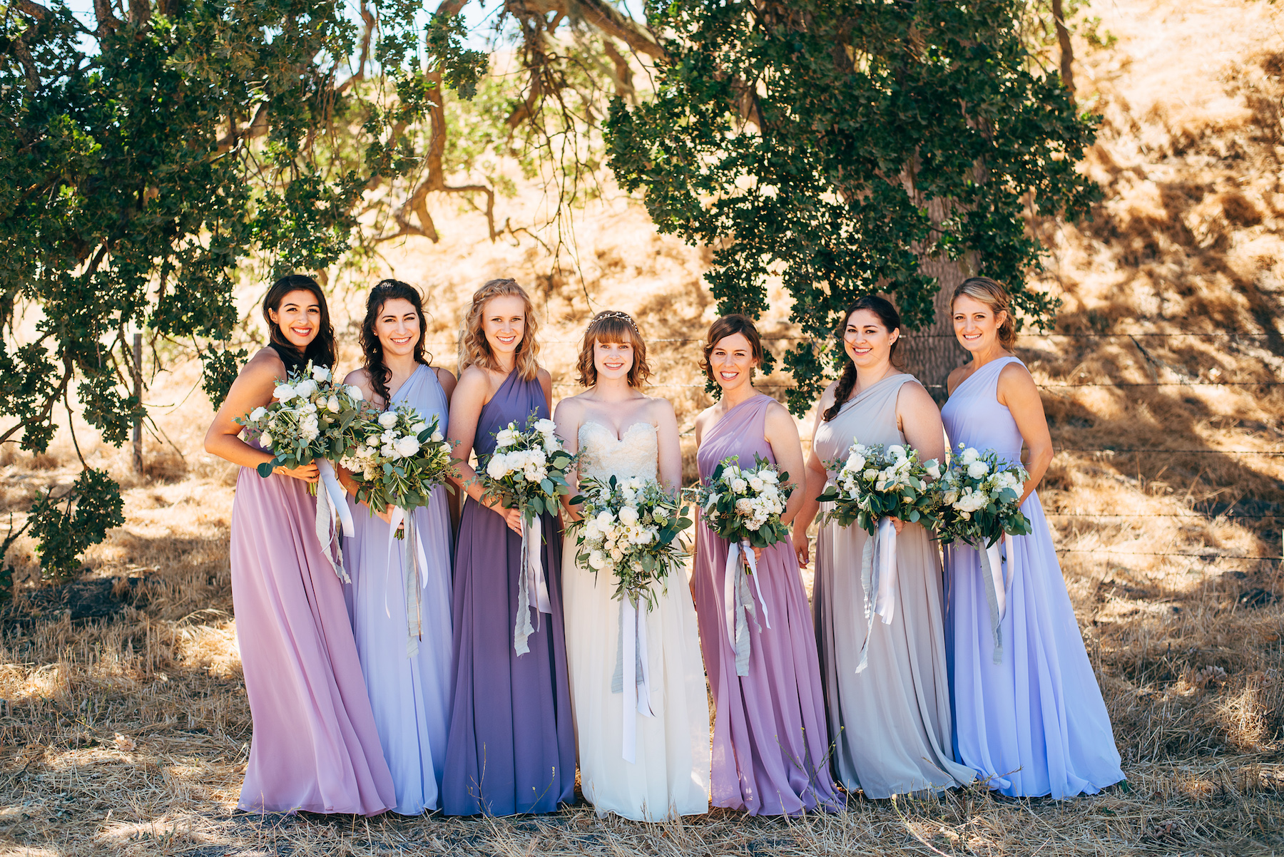 Lavender dresses and white rustic wedding flowers