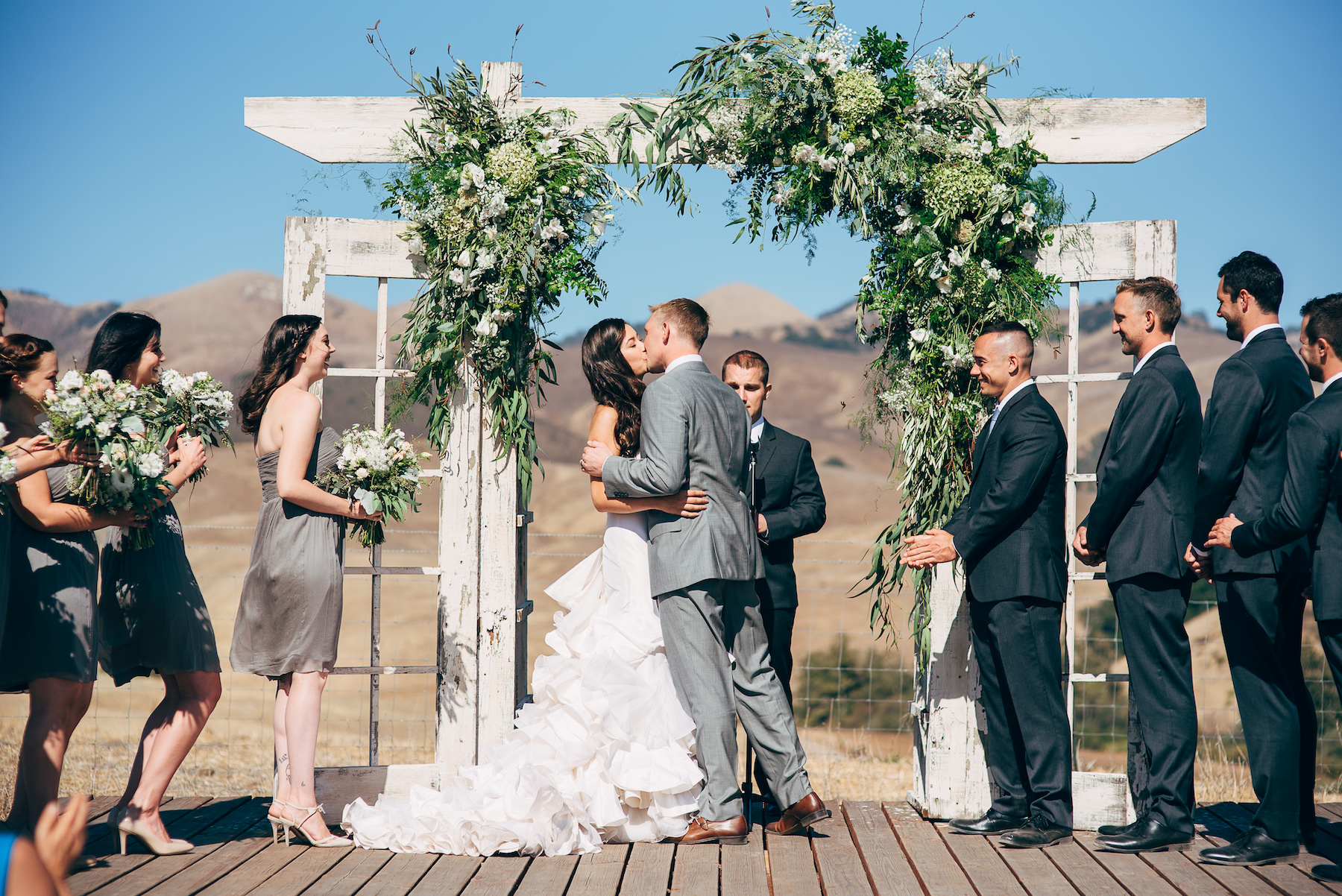 first kiss at Spreafico Ranch wedding ceremony followed by rustic barn wedding with Flowers by Denise