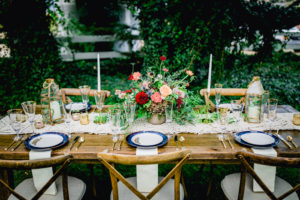 the Meadow at Flying Caballos Ranch with farmtable from All About Events Rentals with lanterns and centerpiece by Flowers by Denise